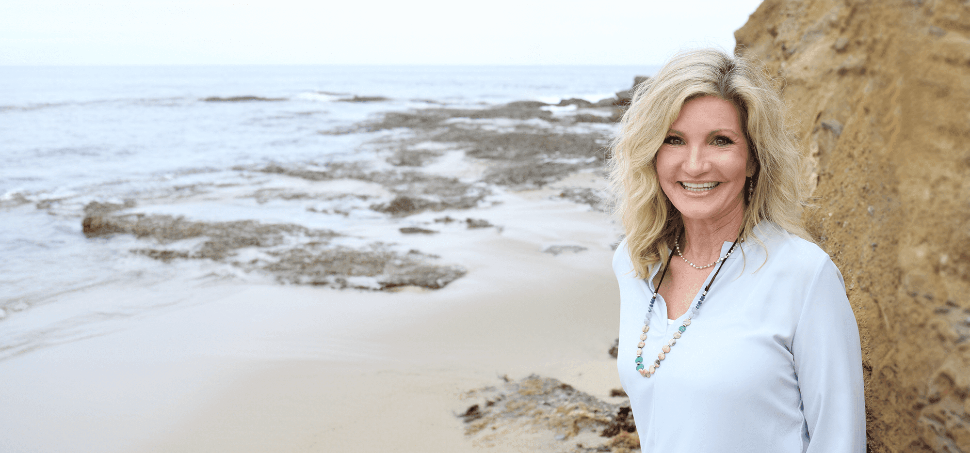 Dr. Lisa Gold standing by the sea